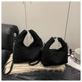 Detail of black plush handbag showing soft faux fur texture and silver metal zipper accents - Large / Black