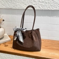 Brown vintage tote bag with silk scarf decoration and textured matte finish shown on table - Brown