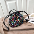 Close-up of colorful sequins and black drawstring closure on fashion bucket bag - Colorful