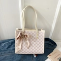 Detail of a beige tote bag with NK pattern, featuring a gold rivet and elegant silk scarf - Off White