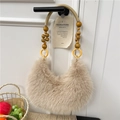 Bohemian beige faux fur hobo bag with unique beaded handle on a white door - Khaki