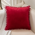 Solid red velvet cushion cover with matching pom-pom fringe on edges for sofa decor - Red