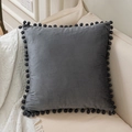 Square dark grey velvet pillow cover with matching decorative pom-pom trim on edges - Gray