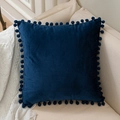 Navy blue velvet throw pillow cover with decorative pom-poms on a white sofa - Navy Blue
