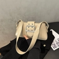 Detail of cream baguette underarm bag with large silver square buckle and grommets - Khaki