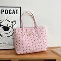 Detail of pink pleated tote bag featuring black bow patterns and gold bow buckle - Pink