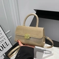 Light khaki leather handbag with suede flap, golden metal lock, and top handle style - Khaki