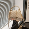 Detail of a beige satchel bag with M-pattern print and luxury gold-tone hardware - Rick Morty McDonald White