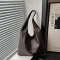 Minimalist deep brown faux leather tote bag for women in a modern home interior setting - Coffee