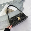Detail of tweed shoulder bag featuring golden metallic twist lock and black leather strap - Black