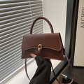 Classic dark brown trapezoid handbag with gold metal lock and elegant top handle - Brown