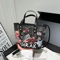 Black graffiti tote bag featuring colorful cartoon bears and a stylish top handle - Black