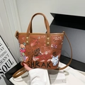 Brown graffiti tote bag with colorful cartoon prints and adjustable crossbody strap - Brown
