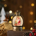 Close-up of bronze vintage Christmas lantern with Santa scene and swirling glitter water - Bronze Santa with Bear
