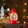 Detail of red Christmas lantern with Santa Claus figurine and glowing snow glitter effects - Red Santa Claus
