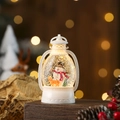Detail of a Christmas snow globe lantern with snowman and deer figures and golden glitter - White Snowman