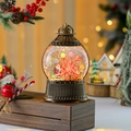 Detail of vintage Christmas lantern with Santa scene and swirling glitter snow effect - Gift Box Santa Claus