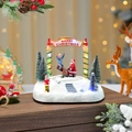 Close-up of LED glowing Christmas music box featuring resin snow scene and Merry Christmas arch - Rotating Seesaw