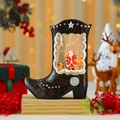 Détail macro de la botte de cow-boy boule à neige avec Père Noël et petit renne - Cerf Père Noël Arbre