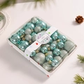 Detail of teal and silver Christmas balls with glitter finish in a gift box packaging - Light Green