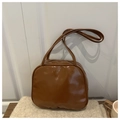 Brown glossy pillow bag on beige knit background with a cozy coffee cup detail - Brown Without Pendant