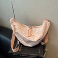 Light pink nylon crescent crossbody bag with woven zipper pulls and wide strap - Pink