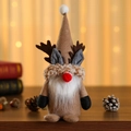 Detailed view of a soft plush Christmas reindeer gnome with antlers on a wooden desk - Yellow Hat Style