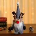 Close-up of a Christmas gnome doll with deer antlers and a warm knitted scarf - Grey With Hood