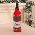 Detailed view of Santa Claus knitted wine bottle cover with soft plush and red green texture - Santa Claus