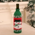 Detail of knitted Christmas wine bottle cover with snowman pattern for table decor - Snowman