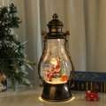 Bronze Christmas lantern with Santa scene, glitter snow, and warm LED light effect - Rotating Santa with Gifts