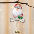 Weihnachtsmann-Anhänger mit Feliz Navidad Schild und Goldglöckchen am Weihnachtsbaum - Weihnachtsmann
