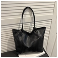 Close-up of the black woven tote bag showing intricate cross-weave texture and metal rings - Magnetic Closure Style (Black) / Black