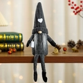 Knitted faceless Christmas gnome in grey sitting on wood with a small coffee cup - Black Braids Style