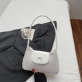 White faux crocodile skin crossbody bag with silver bow accent and shoulder strap - Off White