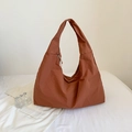 Detailed view of caramel nylon hobo bag featuring zipper closure and wide strap - Brown
