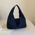 Minimalist navy blue high-capacity tote bag with wide shoulder strap on a white fabric surface - Navy Blue