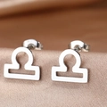 Macro shot of silver Libra zodiac stud earrings on champagne satin background - Silver Libra (F1206-Libra)