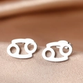 Macro shot of silver stainless steel Cancer zodiac stud earrings on champagne silk fabric - Silver Cancer (F1206-Cancer)