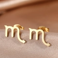 Close-up of golden Scorpio zodiac stud earrings on premium champagne silk fabric - Gold Scorpio (F1205-Scorpio)