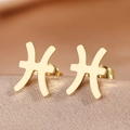 Detailed macro view of golden Pisces zodiac earrings on champagne silk background - Gold Pisces (F1205-Pisces)