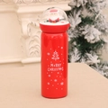 Red Christmas thermal bottle with Santa Claus figurine inside a clear dome lid - Christmas Tree