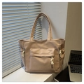 Detail of khaki tote bag featuring large front flap pocket and drawstring side pockets - Khaki