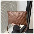 Close-up of brown faux leather bag with V-quilt pattern and silver metallic studs - Brown