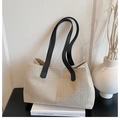 Close-up of beige canvas tote bag with black leather straps on minimalist decor - Beige and Black (without Charm)