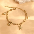 Gold stainless steel ocean bracelet with starfish and seashell charms on peach background - Gold Style (F1371)