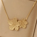 Close-up of golden double flower pendant with brushed texture on box chain necklace - Gold (F1673)