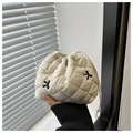 Close-up of a white quilted drawstring pouch with black embroidered cross patterns - White