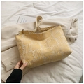 Detailed close-up of yellow and white canvas crossbody bag with textured fabric strap - Yellow