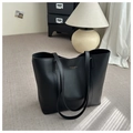 Detail view of black matte leather tote bag featuring gold FASHION & BAGS lettering - Black